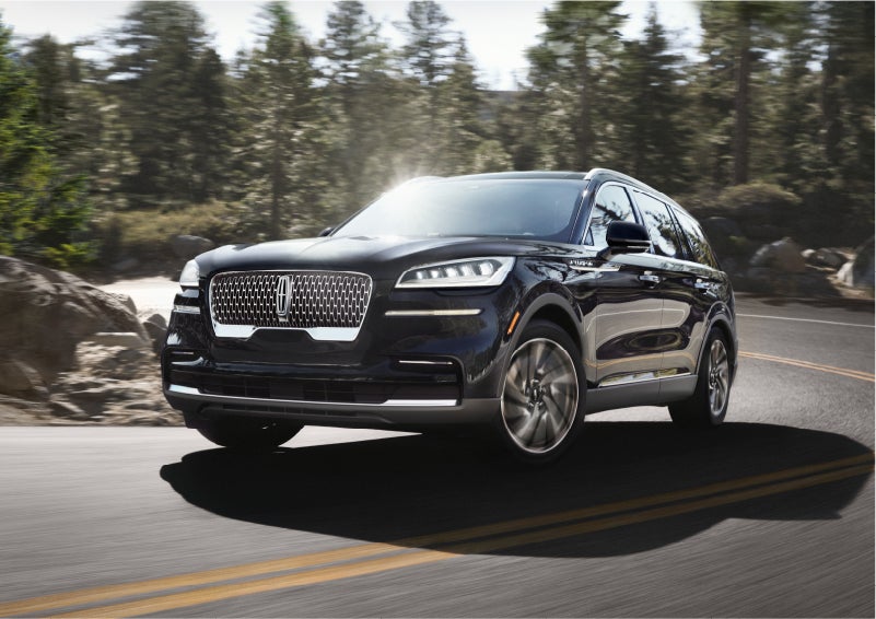 A Lincoln Aviator® SUV is being driven on a winding mountain road | Lincoln Demo 1 in Wooster OH