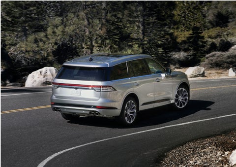 A Lincoln Aviator® is being driven on a winding road | Lincoln Demo 1 in Wooster OH
