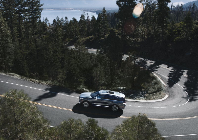 A 2023 Lincoln Aviator® SUV is being driven on a winding mountain road | Lincoln Demo 1 in Wooster OH