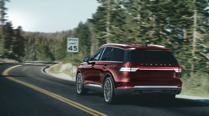 A 2024 Lincoln Aviator® SUV is being driven on a winding mountain road | Lincoln Demo 1 in Wooster OH