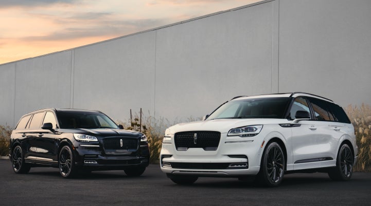 Two Lincoln Aviator® SUVs are shown with the available Jet Appearance Package | Lincoln Demo 1 in Wooster OH