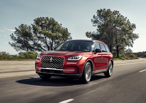 A 2024 Lincoln Corsair® SUV is shown being driven on a country road. | Lincoln Demo 1 in Wooster OH