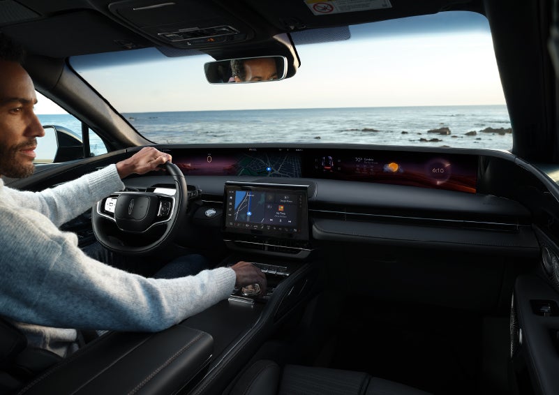 A driver of a parked 2024 Lincoln Nautilus® SUV takes a relaxing moment at a seaside overlook while inside his Nautilus. | Lincoln Demo 1 in Wooster OH